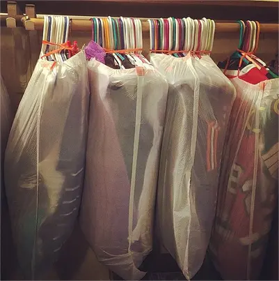 cover hanging clothes in trash bags