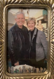 Here's a short alt tag for the image: Smiling couple in a framed photo.