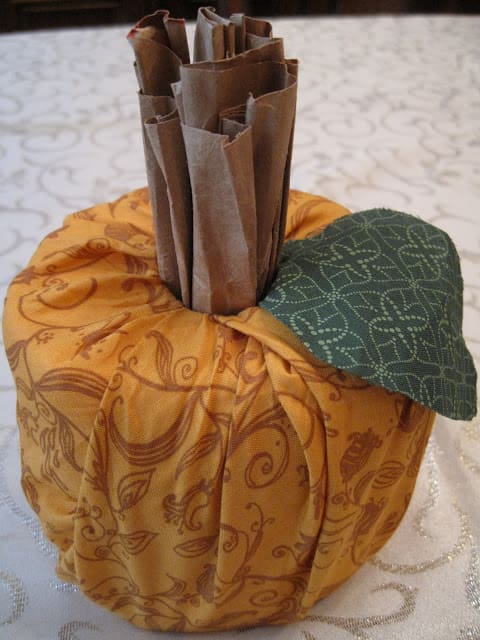 A pumpkin made out of fabric and paper.