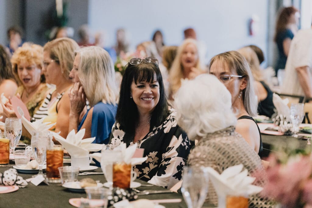 A group of people sitting at a table with food.