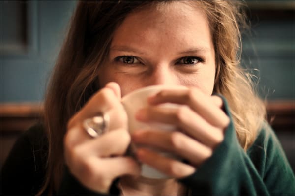 Woman enjoying a warm drink.