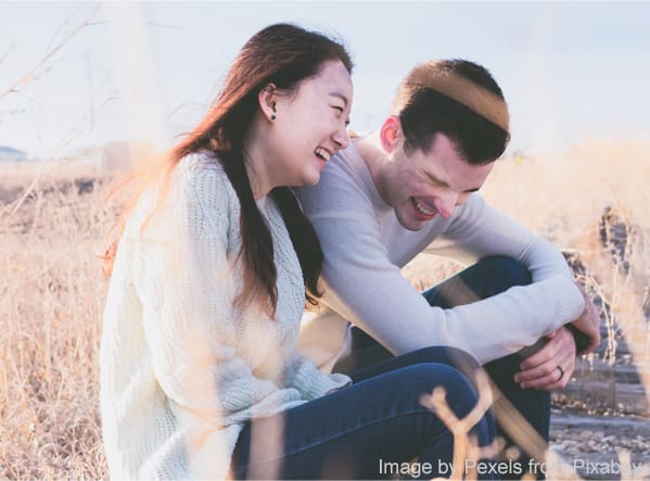 Two people sitting and laughing