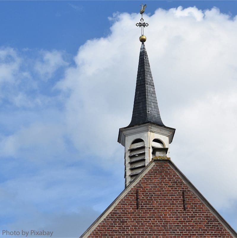 A church steeple with a cross on top of it.