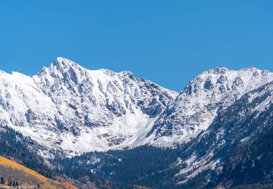 Snow-capped mountains under a blue sky.