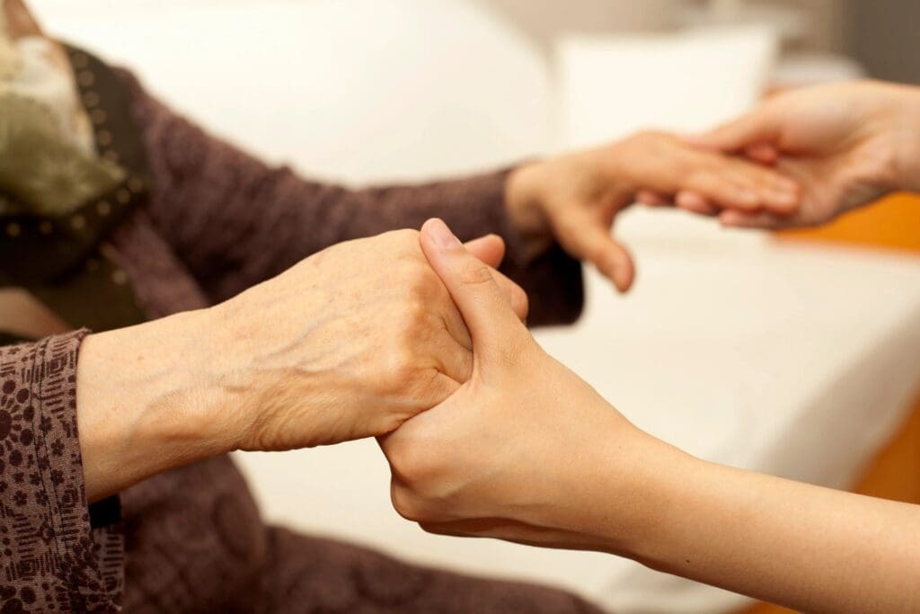 Elderly and young hands holding each other.